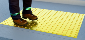 Roll and press the exposed portion onto the surface. Move and stand on the attached end of the mat and lift, then remove, the remaining sections of backing.